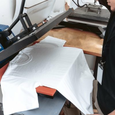 a unrecognizable person working on a iron sublimation. printing concept and graphic design.